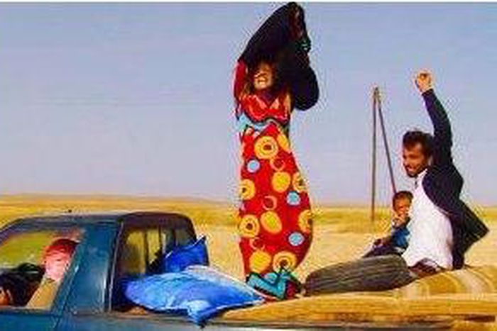 Images show women joyously casting off long black veils and abayas as they flee from ISIS