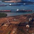 Ships waiting to be loaded are seen near piles of iron ore and bucket-wheel reclaimers at the Fortescue loading dock located at Port Hedland in the Pilbara region of Western Australia, in a file photo. REUTERS/David Gray
