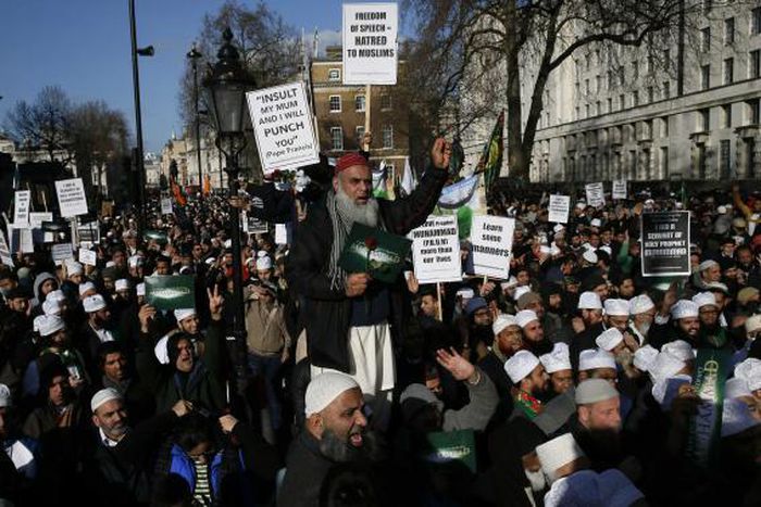 Muslim demonstrators hold placards during a protest against the publication of cartoons depicting the Prophet Mohammad in French satirical weekly Charlie Hebdo, near Downing Street in central London 