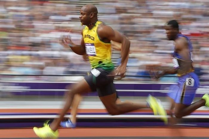 Asafa Powell of Jamaica runs on his way to winning his 100m heat round 1 during the London 2012 Olympic Games at the Olympic Stadium August 4, 2012.     REUTERS/Phil Noble