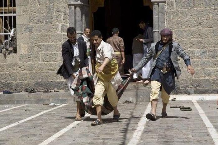 Yemenis carry a body of a man killed in a bomb attack in a mosque in Sanaa, Yemen, Friday, March 20, 2015.