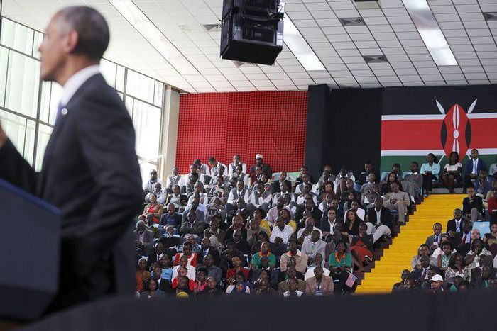 People listen as U.S. President Barack Obama delivers remarks at an indoor stadium in Nairobi July 26, 2015. Obama told Kenyans on Sunday on his first presidential trip to his father's homeland that there was "no limit to what you can achieve" but said...