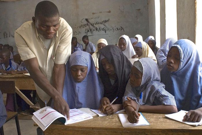 Primary school teacher and pupils in a Nigerian classsroom