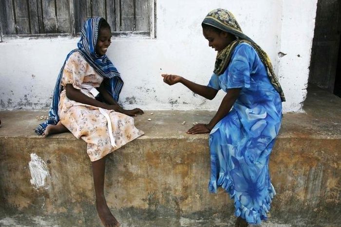 Girls play a game involving the picking up small stones in the village of Bwejuu on Zanzibar island, Tanzania, in a file photo. Picture taken December 2, 2007. REUTERS/Finbarr O'Reilly