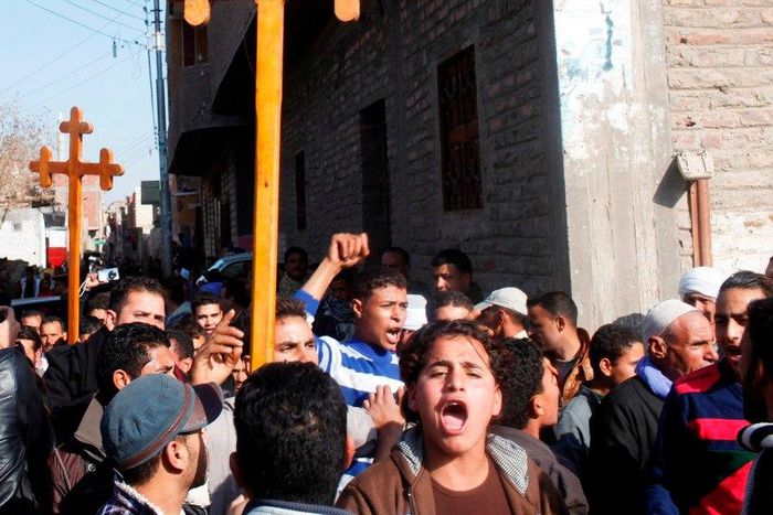 Relatives and neighbours of Egyptian Coptic men killed in Libya chant pro-army slogans during a protest while carrying crosses in al-Our village, in Minya governorate, south of Cairo, February 16, 2015. Thousands of traumatized mourners gathered on Mon...
