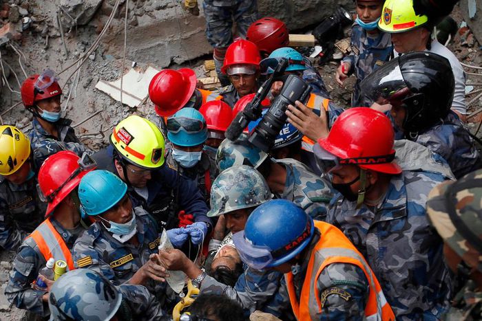 A teenager is carried on a stretcher after being rescued by Nepalese policemen and U.S. rescue workers from a building that collapsed five days after the devastating Earthquake.