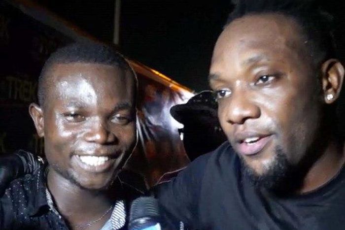 KCee and an elated fan, who won the sum of N50,000 for impressing the singer at a mini dance competition