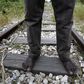 26-year-old Azam from South Sudan stands on rail tracks after failing to flee to Italy in the western Greek town of Patras April 28, 2015.   REUTERS/Yannis Behrakis
