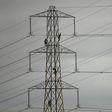 Workers paint an electricity pylon near Lymm, northern England February 18, 2015.   REUTERS/Phil Noble