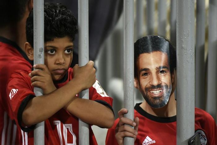 A fan wearing a mask of Egyptian football star Mohamed Salah poses for a photograph prior to the 2019 Africa Cup of Nations qualifier between Egypt and Niger on September 8, 2018 at the Borg el-Arab stadium near the Mediterranean city of Alexandria