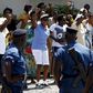 Women sing and dance in front of police during a protest by women against president Pierre Nkurunziza in Bujumbura, Burundi, May 10. 2015.  REUTERS/Goran Tomasevic