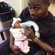 DJ Neptune feeding his daughter