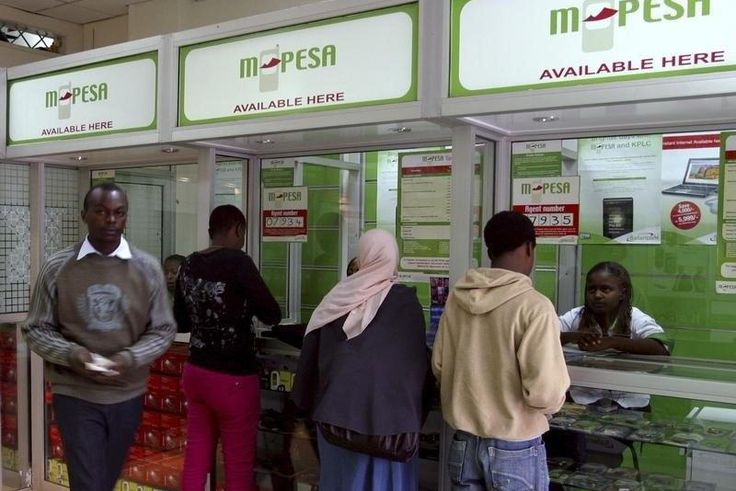 A man leaves an M-PESA booth after a money transaction in Nairobi, in a file photo. Picture taken May 12, 2009. REUTERS/Noor Khamis