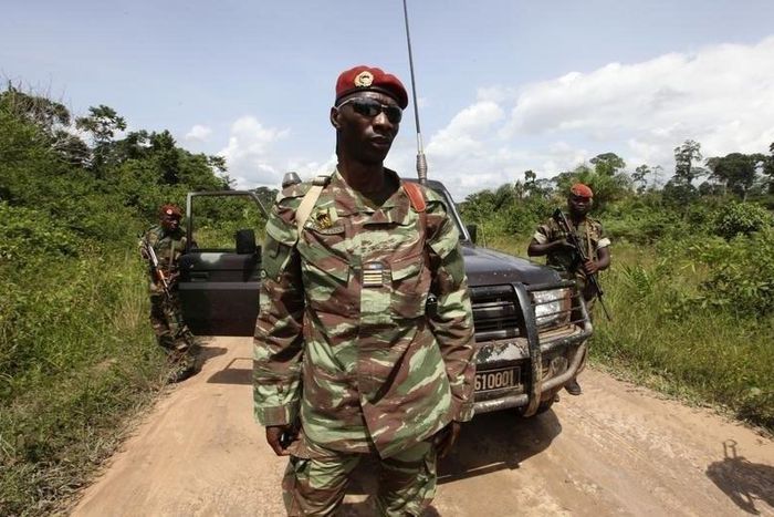 Losseni Fofana of the Ivory Coast Republican forces (FRCI) and commander of the military operation in the Tai area, stands with his men during a patrol on the road to Para village, in the western Tai area near Ivory Coast's border with Liberia, June 17...
