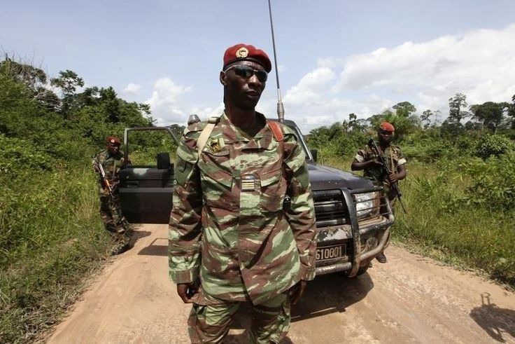 Losseni Fofana of the Ivory Coast Republican forces (FRCI) and commander of the military operation in the Tai area, stands with his men during a patrol on the road to Para village, in the western Tai area near Ivory Coast's border with Liberia, June 17...
