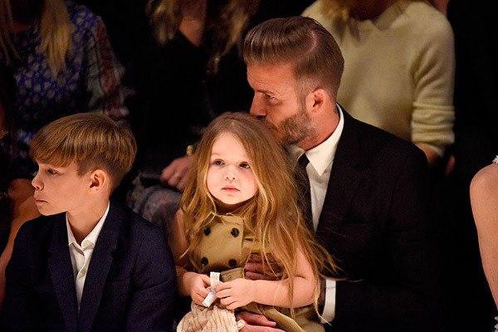 David Beckham kisses her daughter; Harper's hair during the show