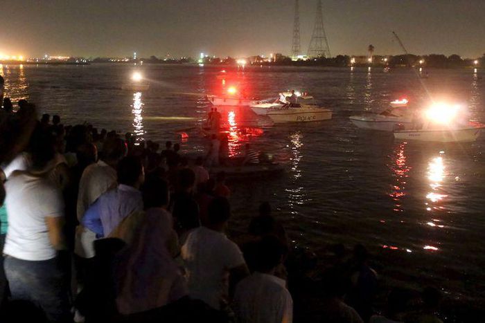 People gather along the banks of the Nile River during a search for the victims of a boat accident on the River Nile in the Warraq area of Giza, Egypt, early July 23, 2015 REUTERS/Mohamed Abd El Ghany