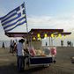 A candy floss stand carrying the Greek national flag.