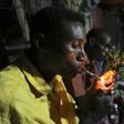 Somali men smoke and chew khat inside a makeshift building at night in Mogadishu August 6, 2014. REUTERS/Feisal Omar