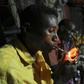Somali men smoke and chew khat inside a makeshift building at night in Mogadishu August 6, 2014. REUTERS/Feisal Omar