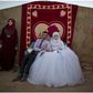 Ahmad Khalid and his bride, Fatheya Mohammed, both 21, sit in front of his family's tent during their wedding ceremony in an informal tent settlement on the outskirts of Mafraq, Jordan, near the Syrian border, on Aug. 7.