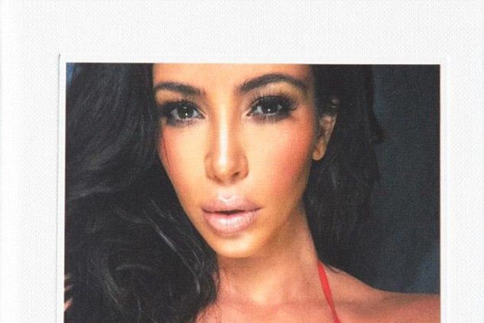 Kim Kardashain spotting a red bikini on the hard cover of the book, Selfish