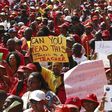 A worker carries a placard during a strike by civil servants outside a hospital in Soweto August 19, 2010.

 Reuters/Siphiwe Sibeko
