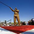 Sudanese President Omar al-Bashir brandishes his trademark cane as he addreses a loyalist rally in Khartoum, the first in the capital since anti-government protests erupted across the country last month