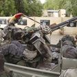 Chadian soldiers drive past flags painted by Boko Haram militants in the recently retaken town of Damasak, Nigeria, March 18, 2015. REUTERS/Emmanuel Braun