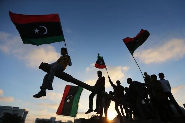 Boys, carrying flags, sit on a tank in Benghazi, March 19, 2014, during the third anniversary of an attack by pro-Gaddafi forces on Benghazi.    REUTERS/Esam Omran Al-Fetori