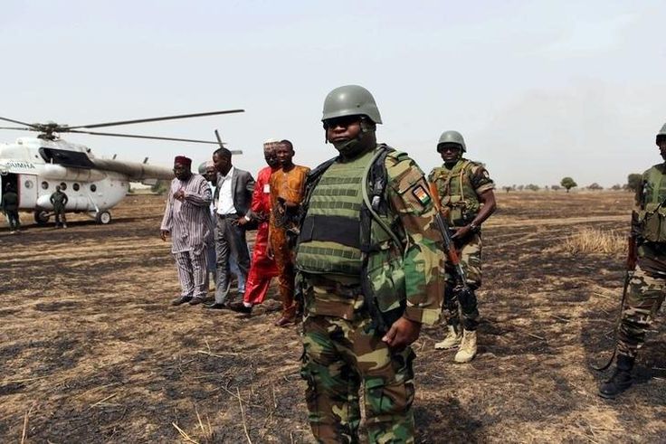 Colonel Barmou Salaou (C), commander of Niger's armed forces in the Diffa region, looks on after landing in Damasak
