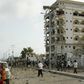 Somali government soldiers stand near the ruins of the Jazeera hotel after an attack in Somalia's capital Mogadishu, July 26, 2015.    REUTERS/Feisal Omar