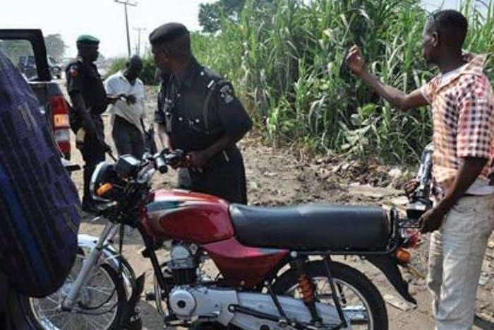 Policeman seizing an okada (illustrative purposes only)