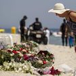 A tourist reads messages left at a makeshift memorial at the beach near the Imperial Marhaba resort, which was attacked by a gunman in Sousse, Tunisia, June 29, 2015. REUTERS/Zohra Bensemra