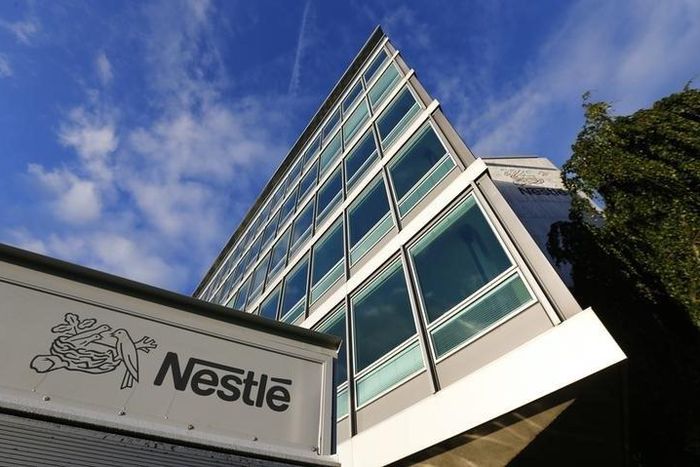 The Nestle logo is pictured on a truck outside the company's headquarters before the nine-month sale figures news conference in Vevey October 17, 2013. REUTERS/Denis Balibouse