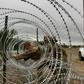 The troops' role so far has primarily been to erect miles of concertina-wire fencing along popular crossing points