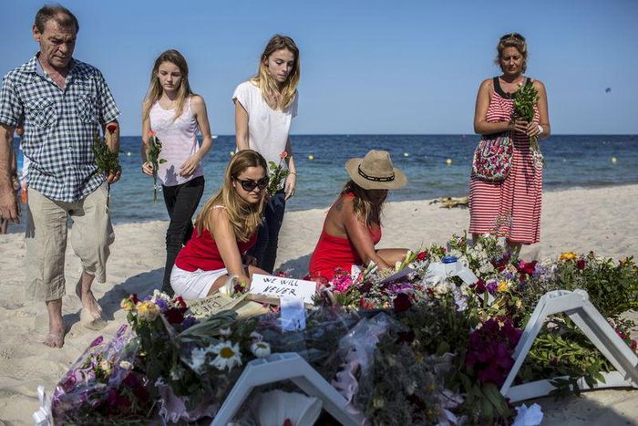 People place flowers on the beach of the Imperial Marhaba resort, which was attacked by a gunman, in Sousse, Tunisia, June 28, 2015. REUTERS/Zohra Bensemra