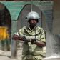 A riot policeman points his rifle towards protesters during a riot in Zanzibar October 19, 2012. REUTERS/Goran Tomasevic