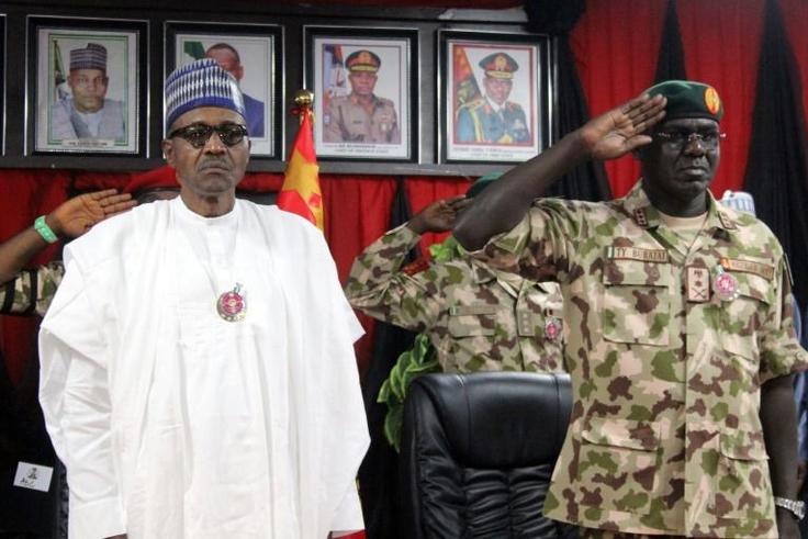 Buhari, left, pictured next to Chief of Army staff Tukur Yusuf Buratai at ceremonies for an annual military conference last November