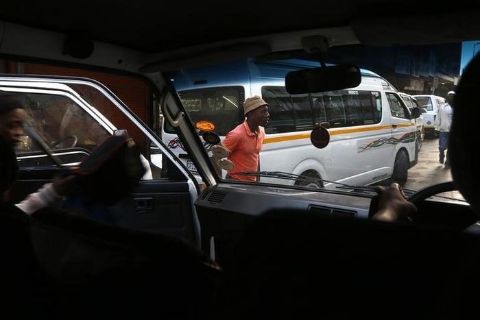 Passengers alight from a minibus taxi in downtown Johannesburg February 21, 2014 Mike Hutchings