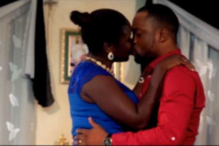 Bukola Awoyemi and Damola Olatunji enjoying a passionate kiss on the set of a movie