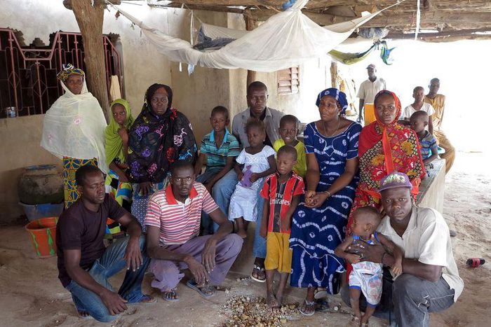 Nfamara Diawarra (C, in gray), 36, poses for a picture with his family in Segoucoura, Senegal, June 18, 2015.  REUTERS/Makini Brice