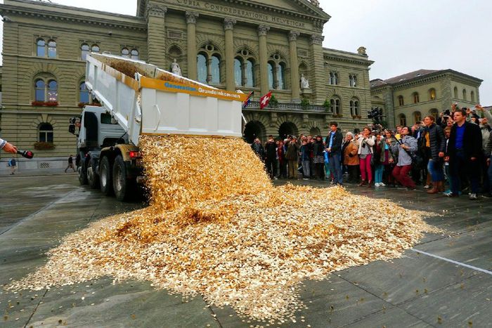 A truck dumps five cent coins in the centre of the Federal Square in Bern, Switzerland.