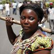 A woman carries an axe during a protest against the president in Bujumbura.