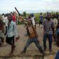 A protestor holds up a dead owl attached to a stick, intended to denigrate the ruling party whose emblem is an eagle, during a protest in Buterere neighbourhood of Bujumbura, Burundi May 12, 2015.    REUTERS/Goran Tomasevic