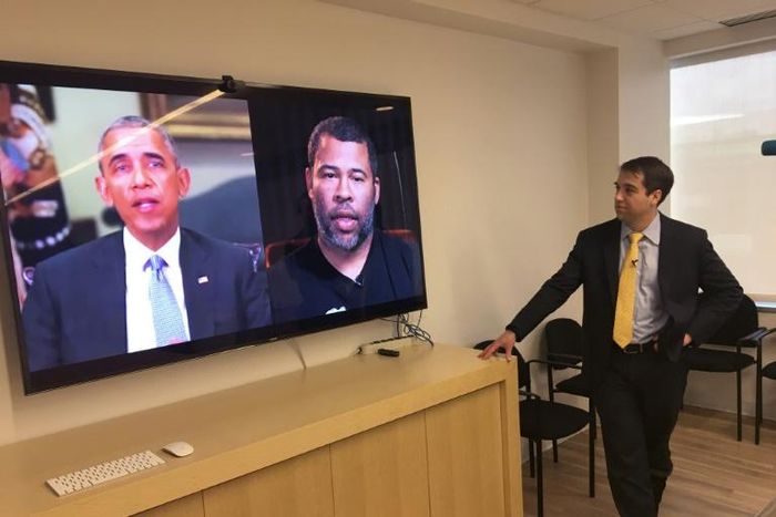Paul Scharre of the Center for a New American Security looks at a "deepfake" video of former US President Barack Obama manipulated to show him speaking words from actor Jordan Peele on January 24, 2019, in Washington