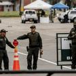 Police officers stand at General Santander Police Academy in Bogota, a day after a deadly car bomb attack