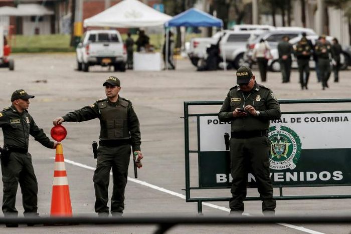Police officers stand at General Santander Police Academy in Bogota, a day after a deadly car bomb attack