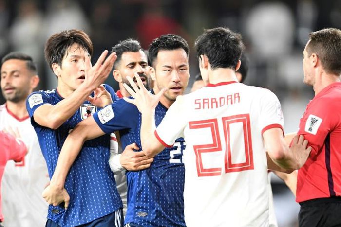 Iran forward Sardar Azmoun (2nd-R) confronts Japan midfielder Genki Haraguchi (L) during the 2019 AFC Asian Cup semi-final football match between Iran and Japan at the Hazza Bin Zayed Stadium in Al-Ain on January 28, 2019