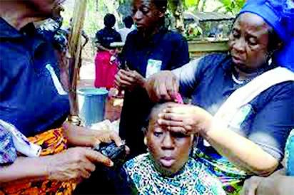 A widow getting her hair shaved. (Vanguard)
